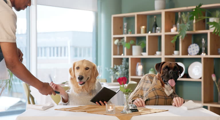 Cute dogs enjoying café dining with waiter, cozy interior, flowers, and natural light.