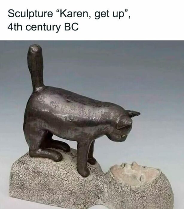 Ancient bronze cat sculpture playfully waking a sleeping human figure, humorous 4th century BC art.