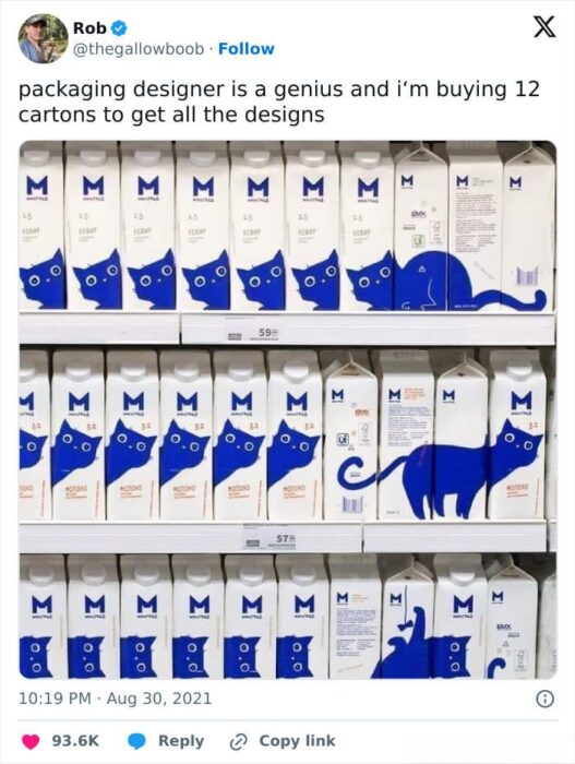 Blue cat-themed milk cartons displayed creatively on grocery store shelves for unique packaging appeal.