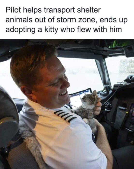 Joyful pilot flying rescue mission with adorable kitten in cockpit during storm.